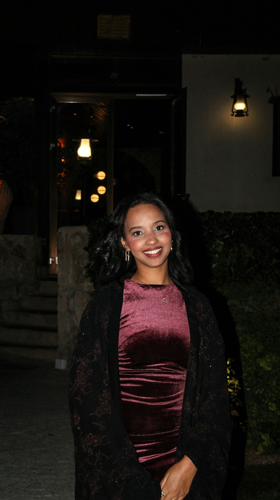 Smiling Latina woman in elegant outfit at an evening event